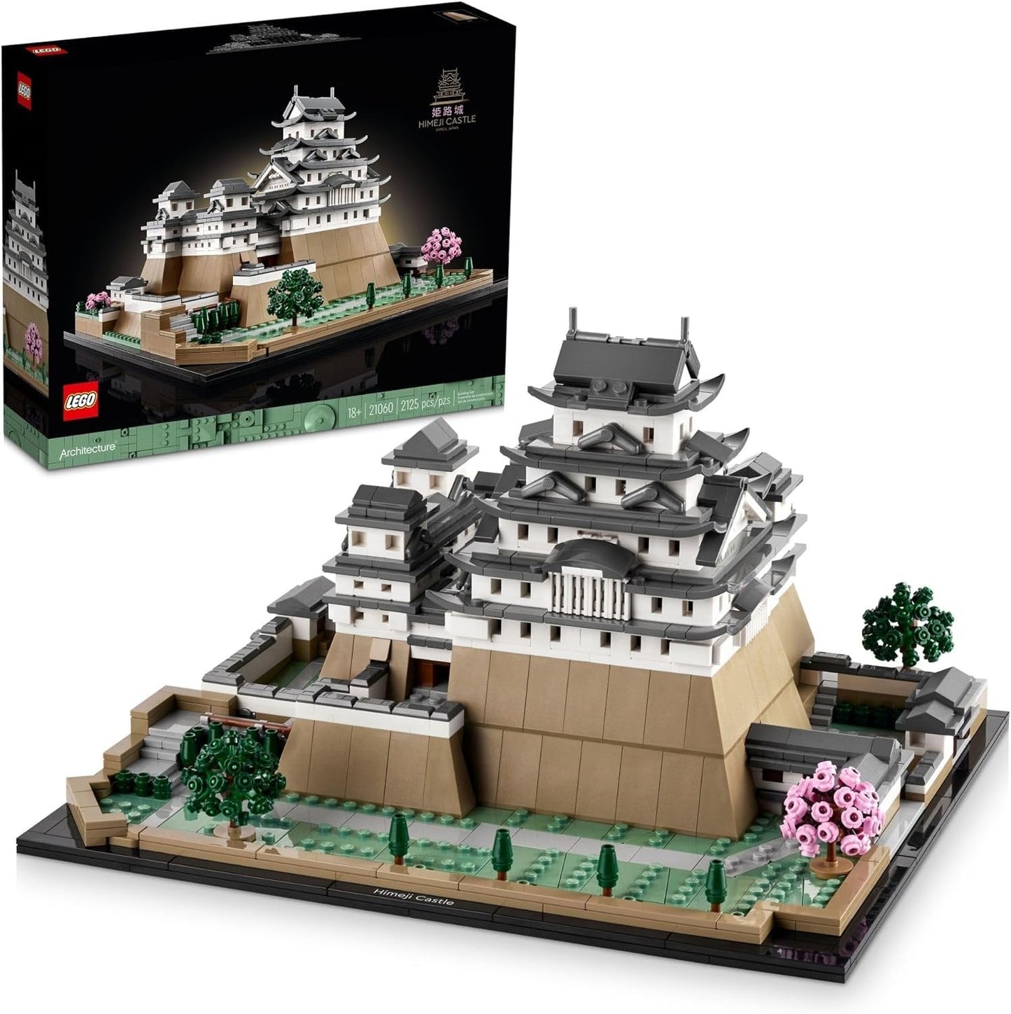 LEGO 21060 Himeji Castle model showcasing the white castle with curved roofs, surrounded by cherry trees with pink blossoms, set on a landscaped base.