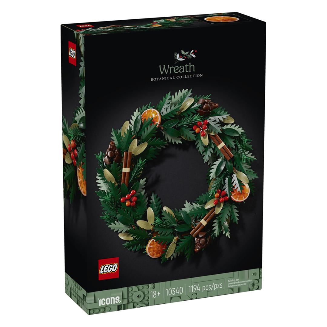 LEGO Icons 10340 Wreath featuring fir branches, berries, orange slices, cinnamon sticks, and pinecones, suitable for wall or table decoration.