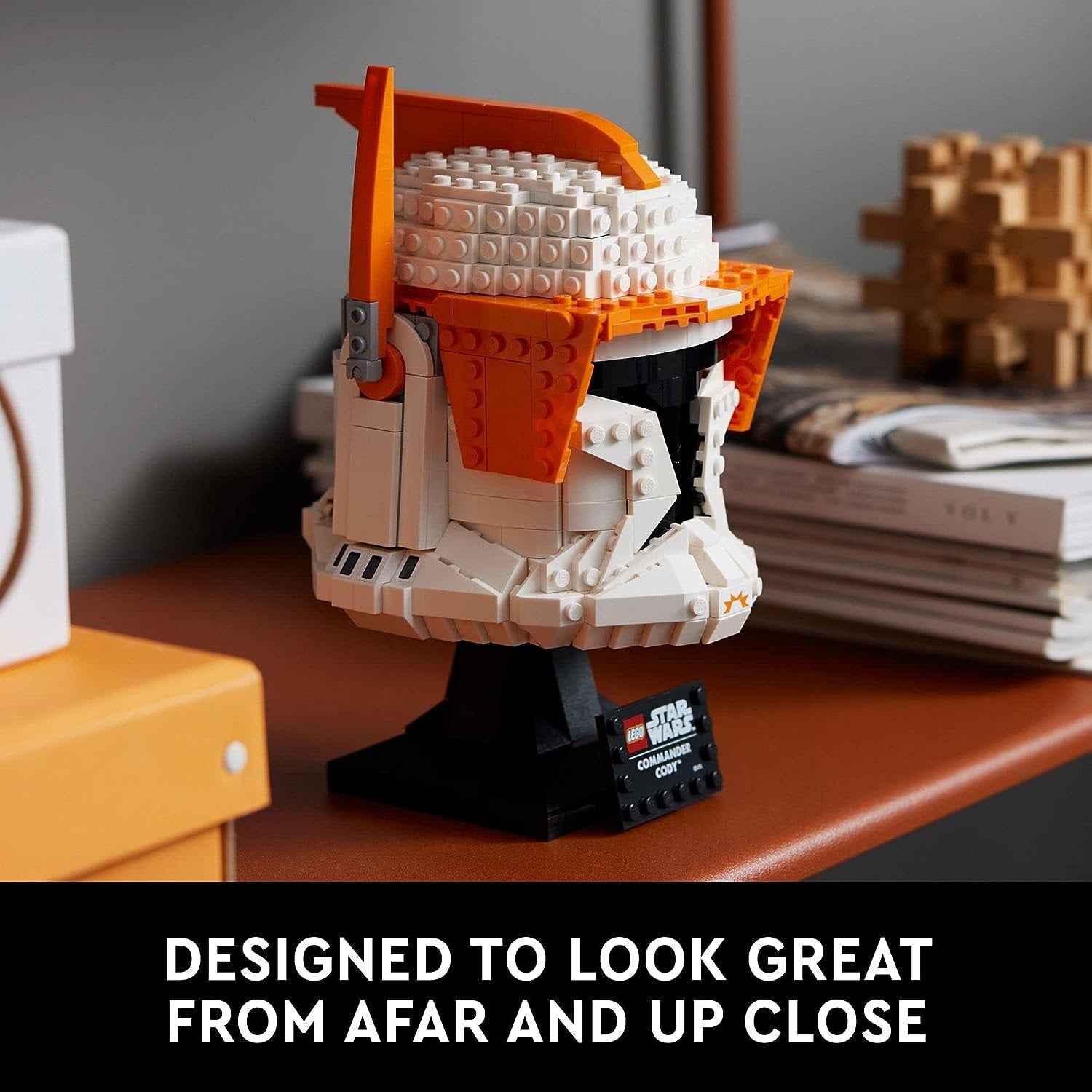 LEGO 75350 Clone Commander Cody Helmet set showcasing a detailed helmet with orange accents, black visor, and a brick-built stand with a nameplate.​
