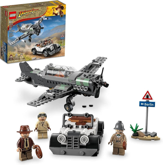 LEGO 77012 Indiana Jones Fighter Plane Chase set featuring a detailed fighter plane with propeller and stud shooters, a vintage convertible car, and minifigures of Indiana Jones, Professor Henry Jones Sr., and a fighter pilot.​