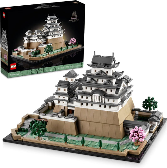 LEGO 21060 Himeji Castle model showcasing the white castle with curved roofs, surrounded by cherry trees with pink blossoms, set on a landscaped base.​

